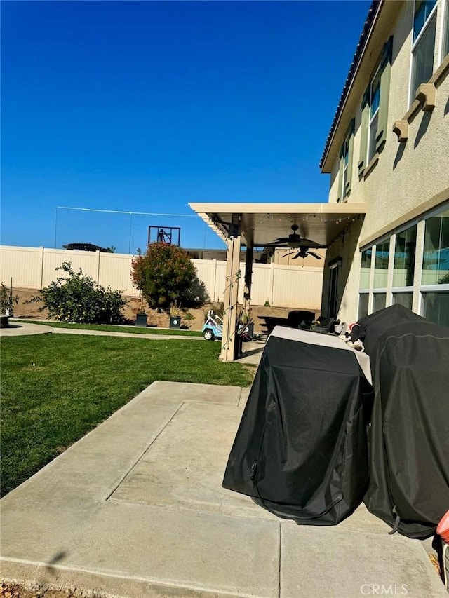 view of patio with ceiling fan and a grill