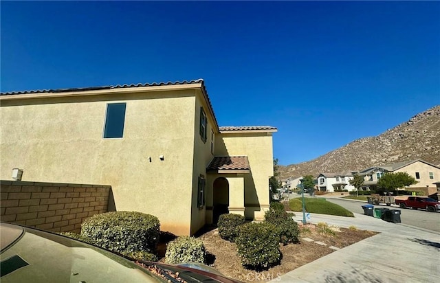 view of side of property with a mountain view