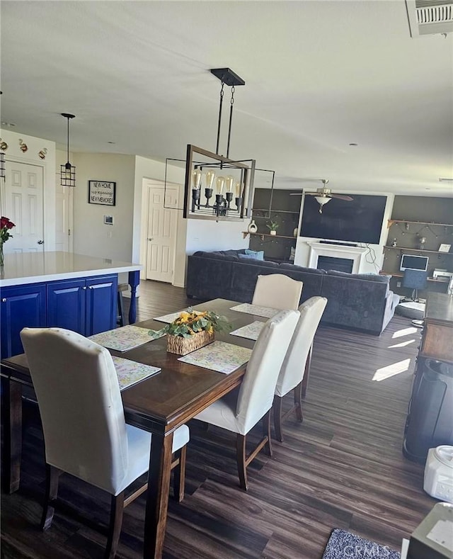 dining space with dark hardwood / wood-style flooring and ceiling fan