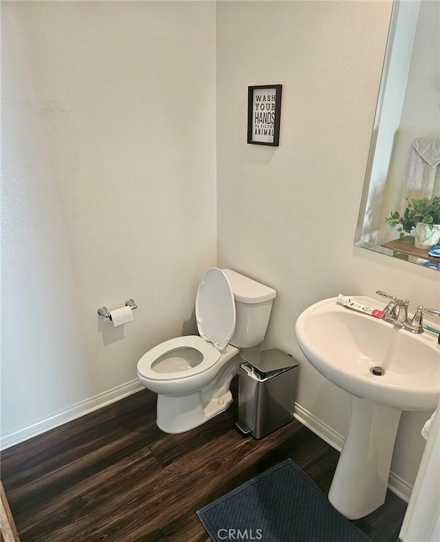 bathroom featuring toilet and hardwood / wood-style flooring