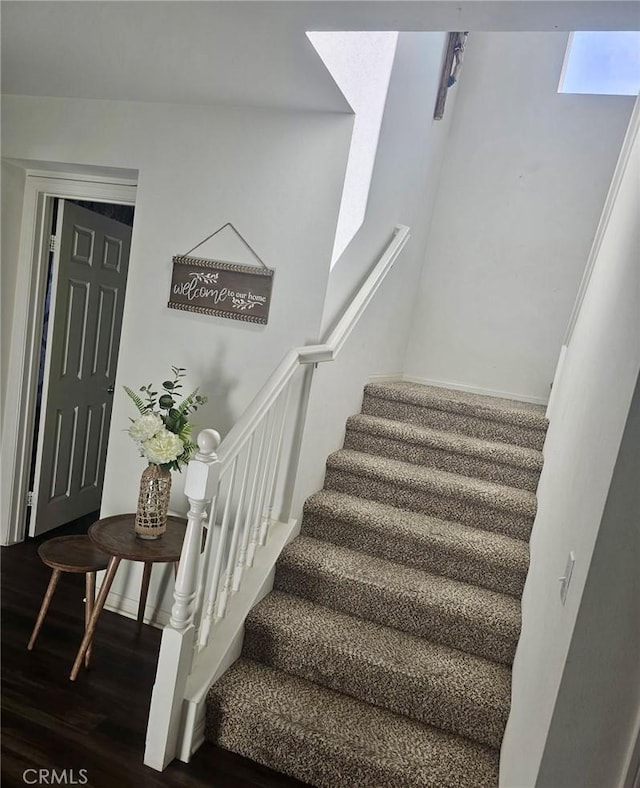 stairs with hardwood / wood-style flooring