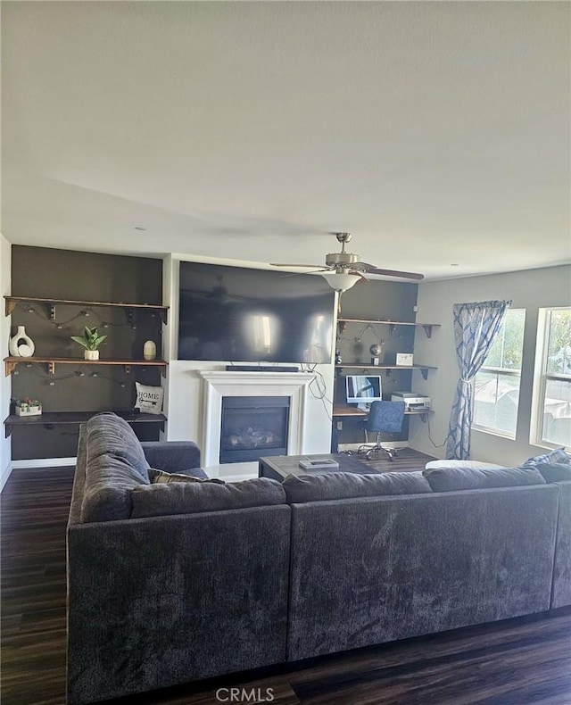 living room with dark hardwood / wood-style floors and ceiling fan