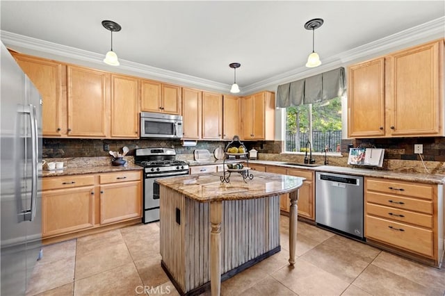 kitchen featuring light stone countertops, appliances with stainless steel finishes, pendant lighting, and sink