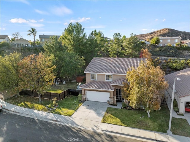 view of front of home with a mountain view, a garage, and a front yard