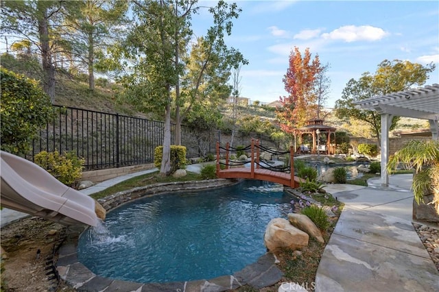 view of swimming pool with a gazebo and a water slide