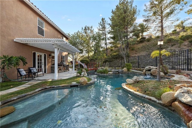 view of pool with pool water feature, a pergola, area for grilling, and a patio area