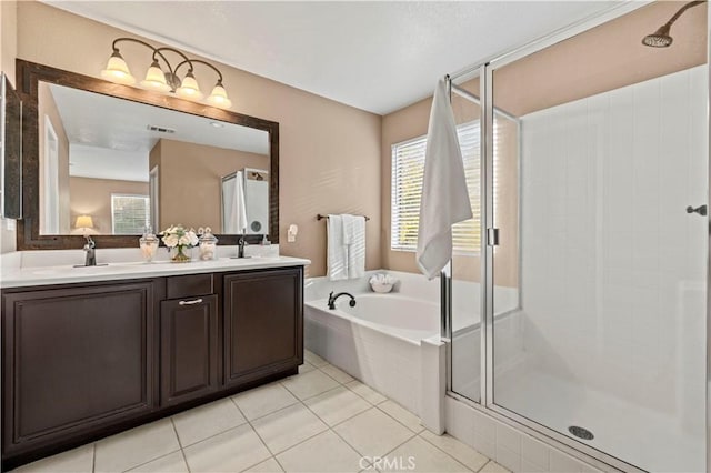 bathroom featuring tile patterned flooring, vanity, and separate shower and tub