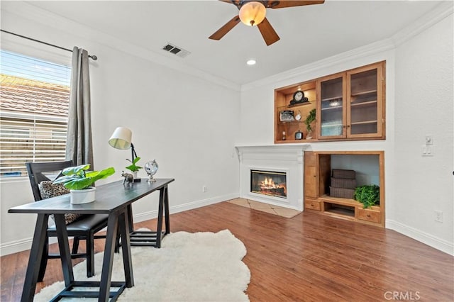 office featuring ceiling fan, dark hardwood / wood-style flooring, and ornamental molding