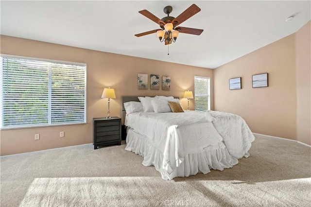 bedroom with ceiling fan and light colored carpet