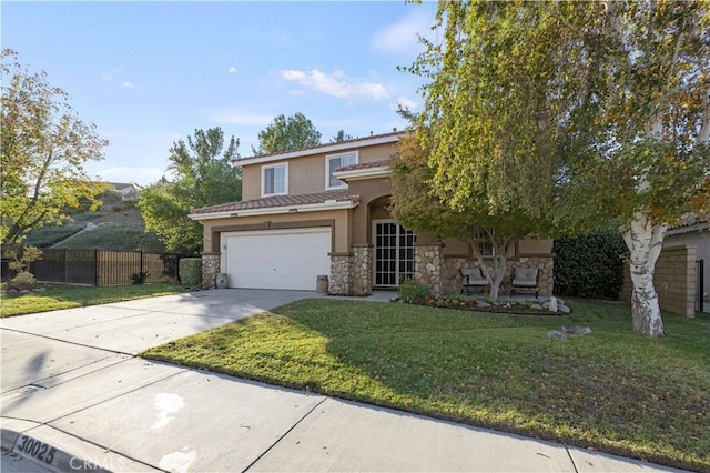 view of front of property with a garage and a front lawn