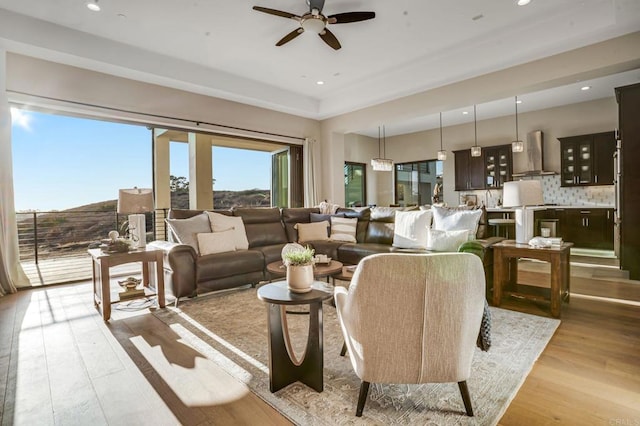 living room featuring ceiling fan and light wood-type flooring