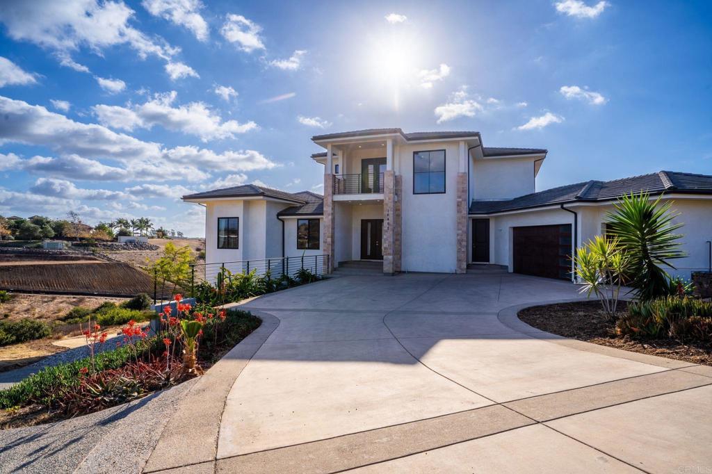 view of front of home with a balcony and a garage