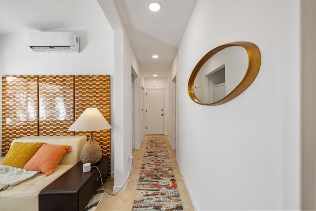 hall featuring an AC wall unit and light tile patterned flooring