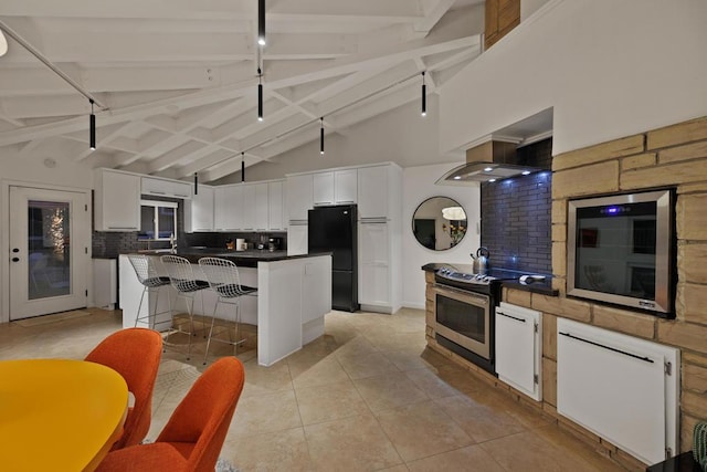 kitchen with backsplash, stainless steel electric range, beam ceiling, white cabinets, and a center island