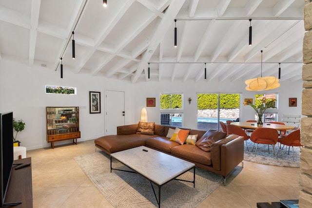 tiled living room with beam ceiling and a towering ceiling