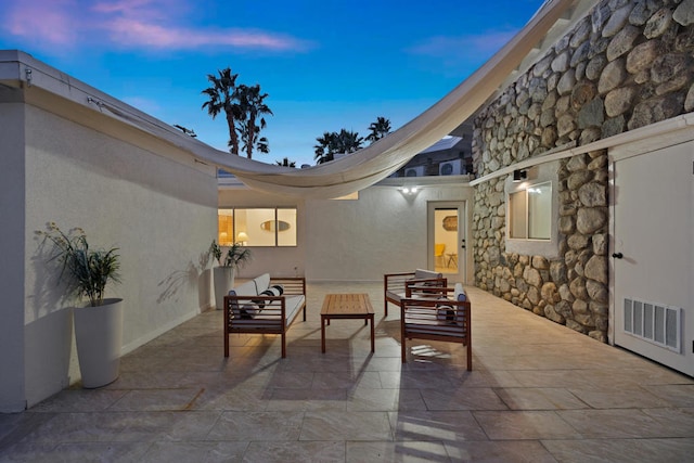 patio terrace at dusk with an outdoor living space