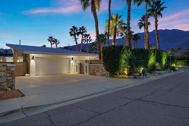 view of front of property with a mountain view and a garage