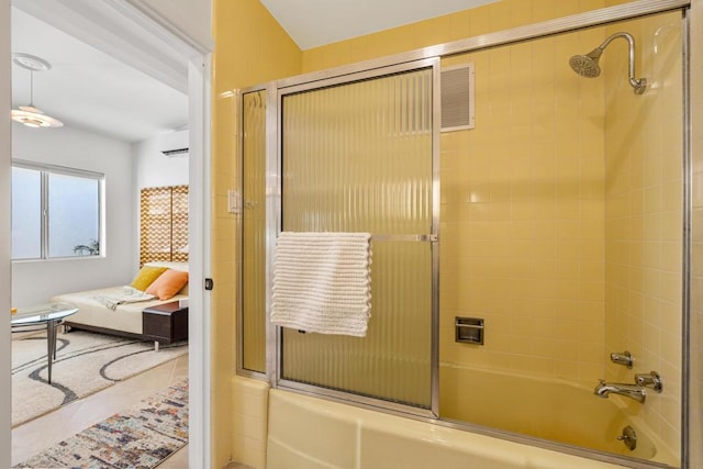 bathroom with enclosed tub / shower combo and a wall mounted AC