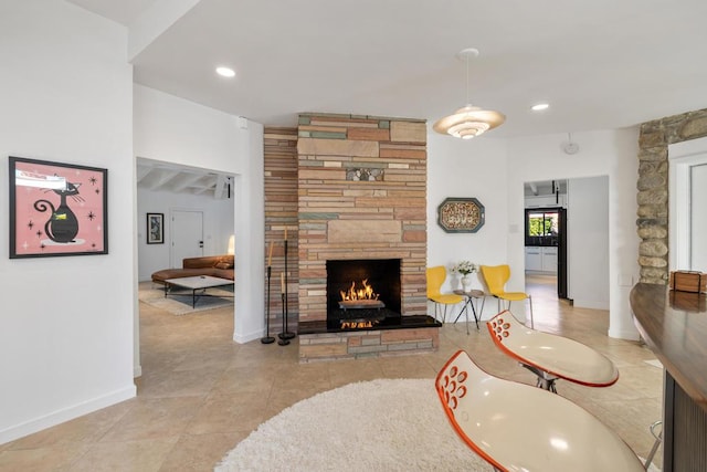 living room featuring a stone fireplace