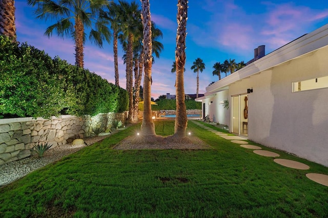 view of yard at dusk