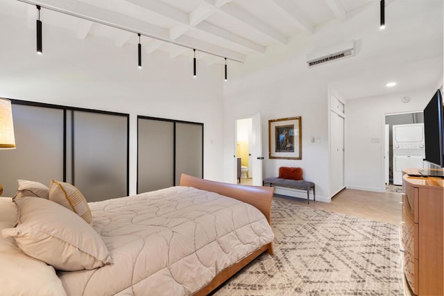 bedroom with beam ceiling and track lighting