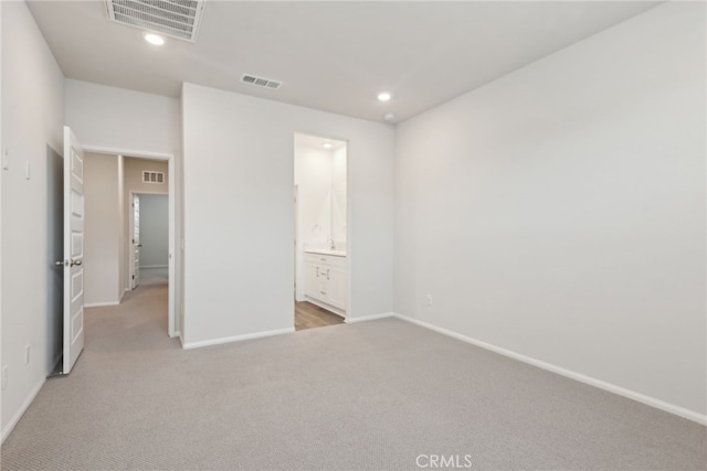 unfurnished bedroom featuring visible vents, light colored carpet, and recessed lighting