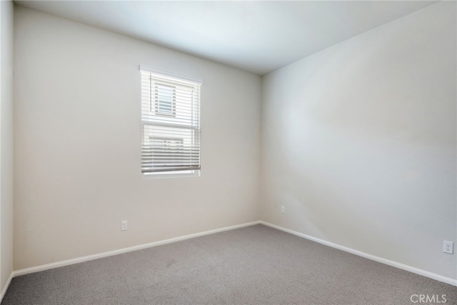 empty room with carpet floors and baseboards