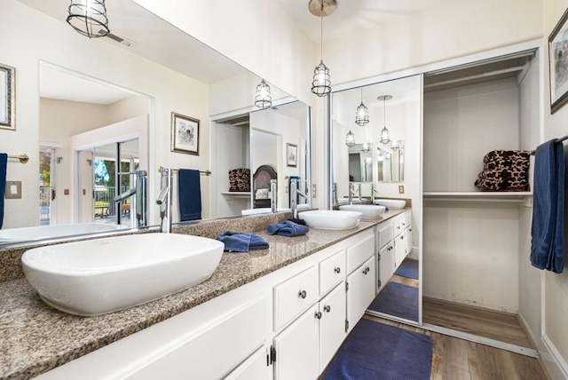 bathroom with vanity and hardwood / wood-style flooring