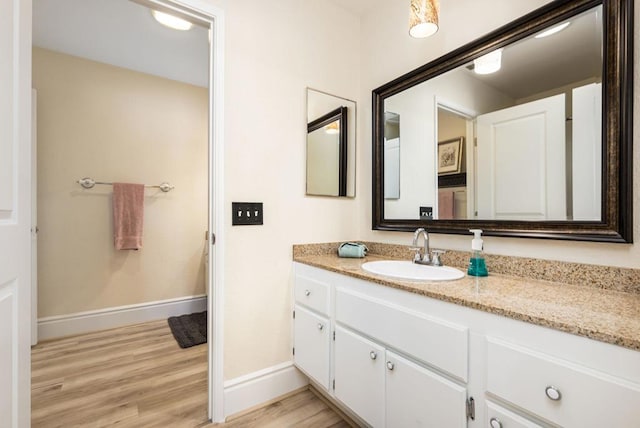 bathroom featuring hardwood / wood-style floors and vanity