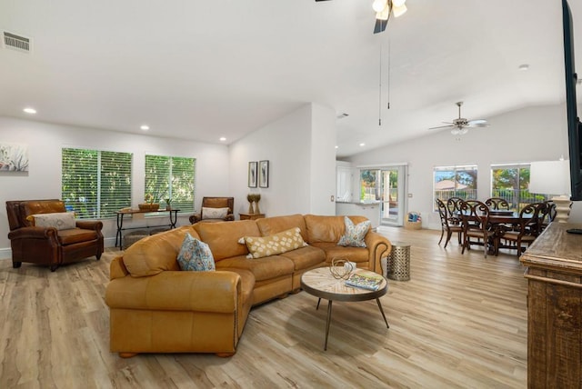 living room featuring ceiling fan, light hardwood / wood-style flooring, and vaulted ceiling