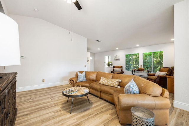 living room with ceiling fan, lofted ceiling, and light hardwood / wood-style flooring