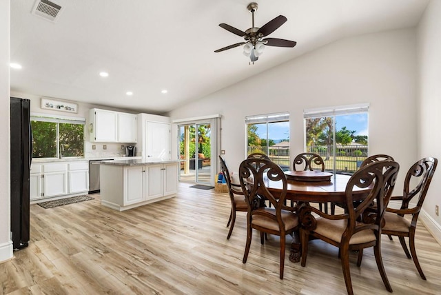 dining space with light wood-type flooring, high vaulted ceiling, ceiling fan, and a healthy amount of sunlight