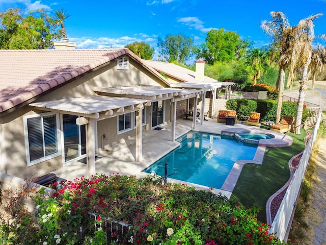 rear view of property featuring a pergola, a swimming pool with hot tub, and a patio