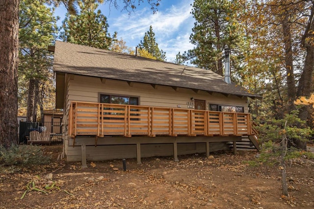 back of property with a wooden deck