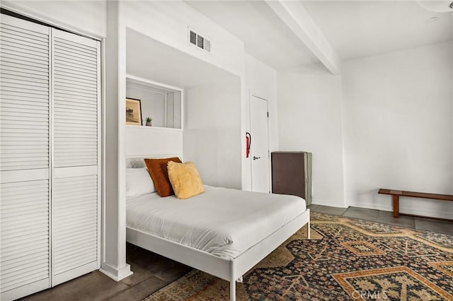 bedroom featuring dark hardwood / wood-style floors and a closet