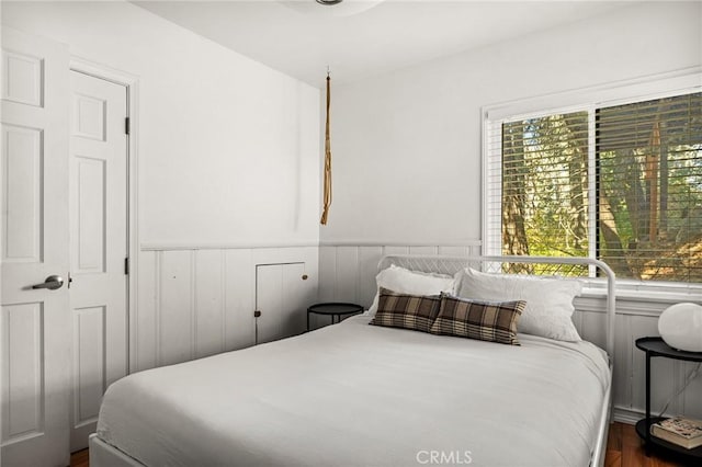 bedroom with dark wood-type flooring