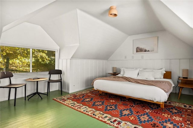 bedroom featuring hardwood / wood-style floors and vaulted ceiling