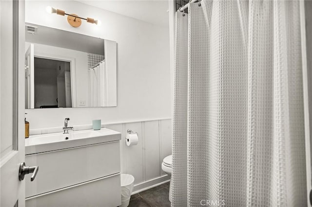 bathroom featuring vanity and toilet