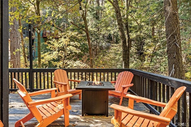 deck featuring an outdoor fire pit