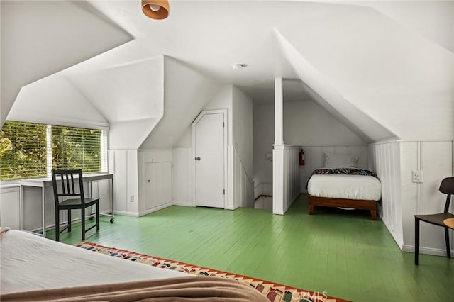 bedroom with hardwood / wood-style floors and vaulted ceiling