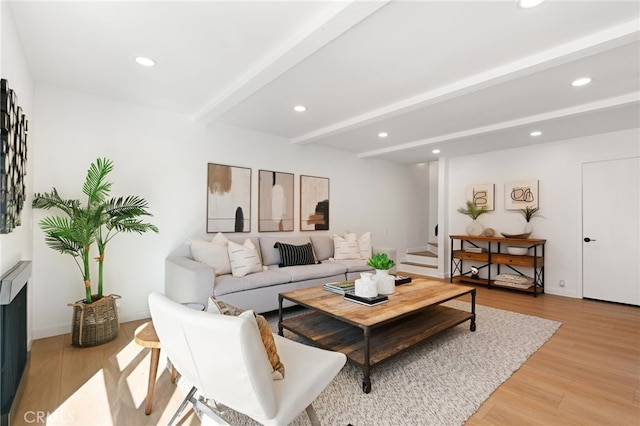 living room with light wood-type flooring and beamed ceiling