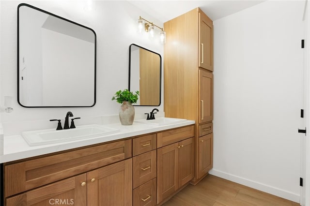 bathroom with vanity and hardwood / wood-style floors