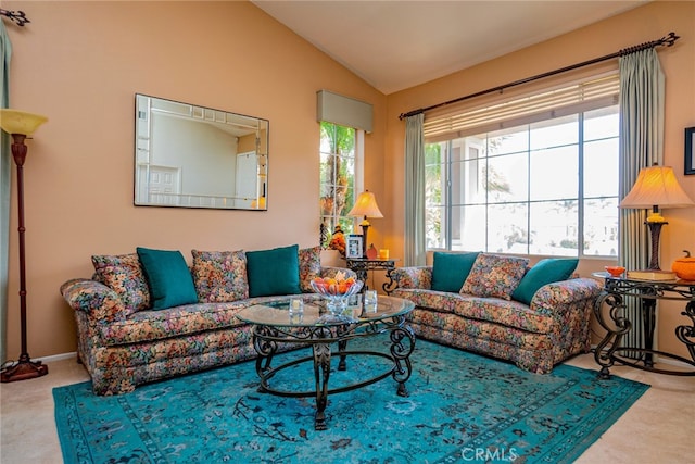 carpeted living room with lofted ceiling