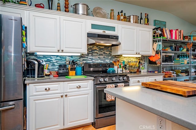 kitchen featuring decorative backsplash, white cabinetry, and stainless steel appliances