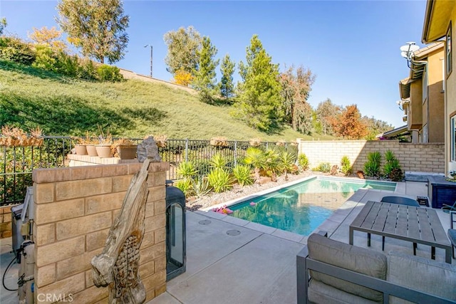 view of swimming pool featuring a fenced backyard, a fenced in pool, and a patio