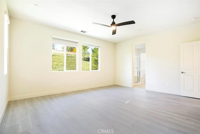 unfurnished room featuring light wood finished floors, a ceiling fan, and baseboards