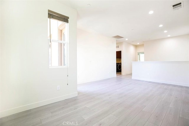 unfurnished room featuring visible vents, light wood-style flooring, washer / dryer, and recessed lighting