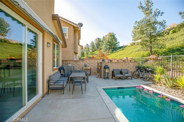 view of swimming pool with a patio area and a fenced backyard