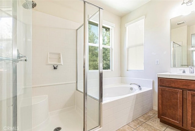 bathroom with a stall shower, visible vents, tile patterned flooring, vanity, and a bath