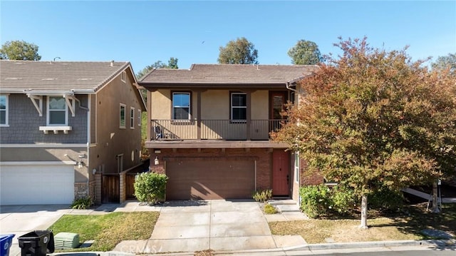 multi unit property featuring a garage, concrete driveway, and stucco siding